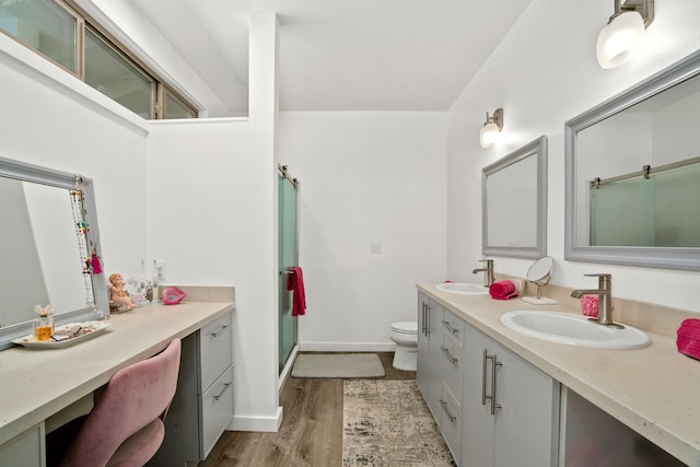 6421-L Hauiki Rd, Kapaa, HI 96746 - bathroom featuring double vanity, toilet, wood finished floors, a shower with shower door, and baseboards