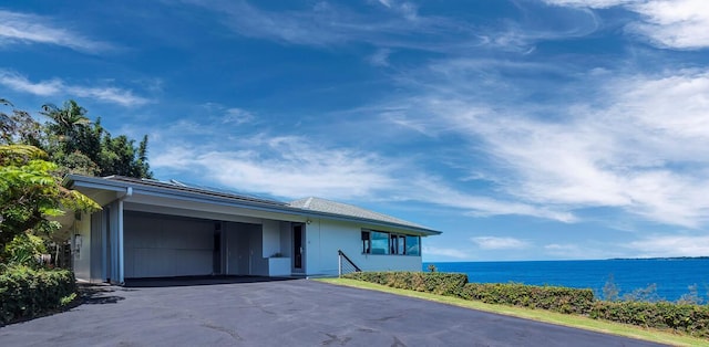224 Paukaa Dr, Hilo, HI 96720 - ranch-style house with driveway, an attached carport, and a water view