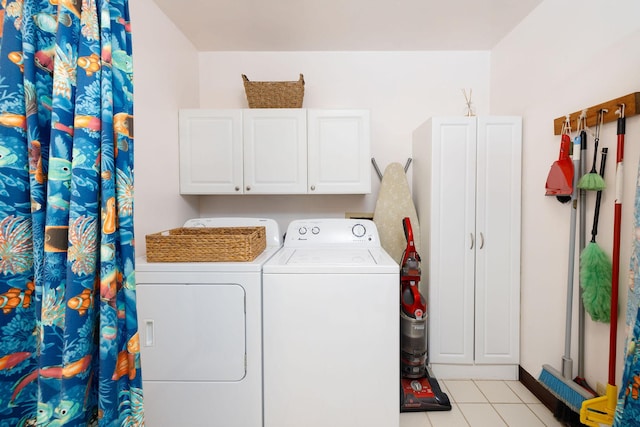 73-1291 Kaiminani Dr, Kailua-Kona, HI 96740 - laundry room featuring washing machine and clothes dryer, light tile patterned floors, and cabinet space