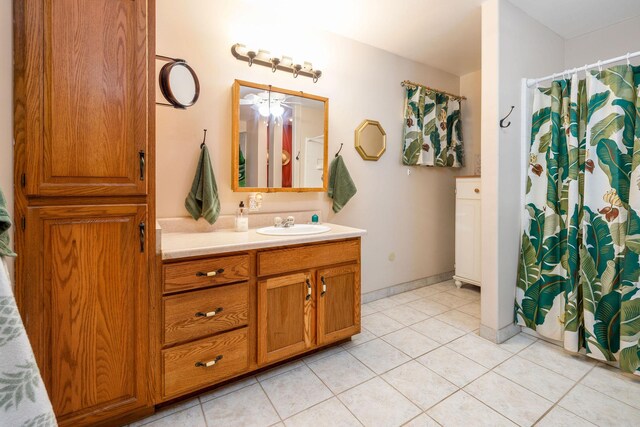 73-1291 Kaiminani Dr, Kailua-Kona, HI 96740 - bathroom featuring vanity, tile patterned flooring, a shower with curtain, and baseboards