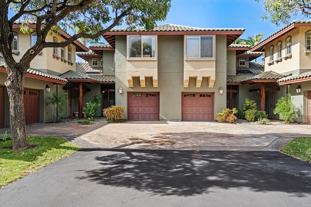 68-1125 Kaniku Dr Unit 1103, Kamuela, HI 96743 - view of front facade with driveway, an attached garage, stucco siding, and a tile roof