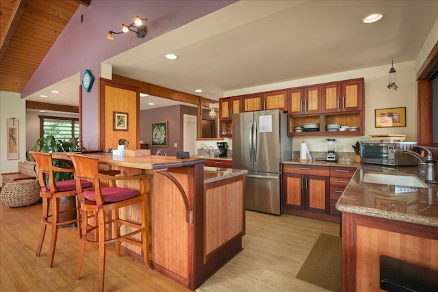 82-6289 Kahauloa St, Captain Cook, HI 96704 - kitchen with freestanding refrigerator, brown cabinets, a sink, open shelves, and recessed lighting