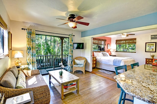 82-6289 Kahauloa St, Captain Cook, HI 96704 - bedroom with access to exterior, multiple windows, and wood finished floors