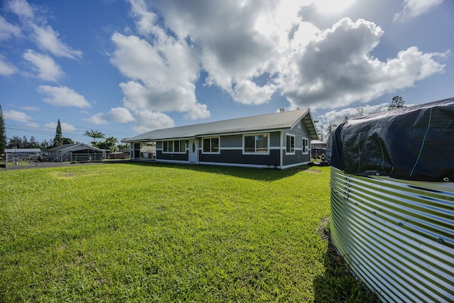 16-2042 Sandalwood Dr, Pahoa, HI 96778 - rear view of property featuring a lawn and metal roof