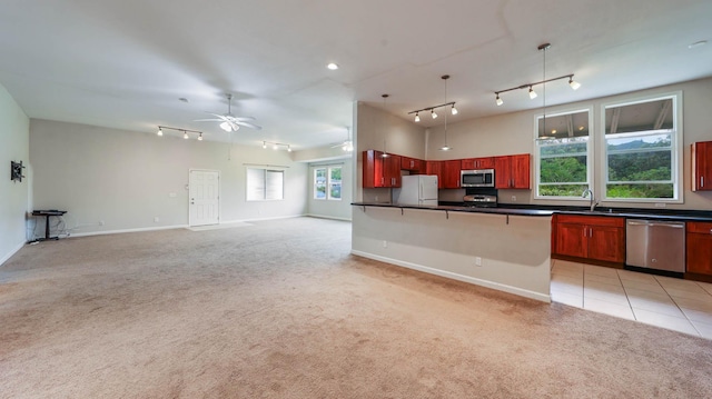 4460 Punee Rd Unit A, Koloa, HI 96756 - kitchen with appliances with stainless steel finishes, track lighting, dark countertops, and reddish brown cabinets