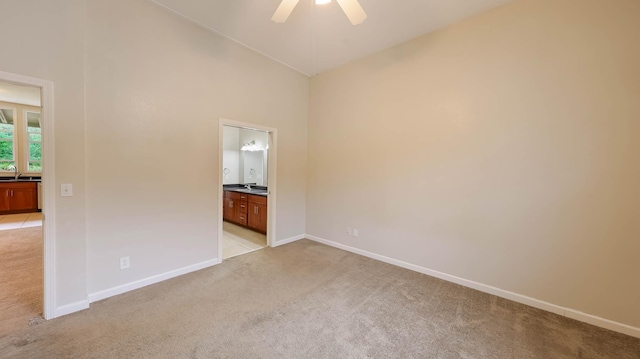4460 Punee Rd Unit A, Koloa, HI 96756 - unfurnished bedroom featuring light colored carpet, baseboards, connected bathroom, a ceiling fan, and high vaulted ceiling