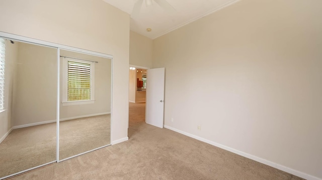 4460 Punee Rd Unit A, Koloa, HI 96756 - unfurnished bedroom with light colored carpet, baseboards, a closet, and a towering ceiling
