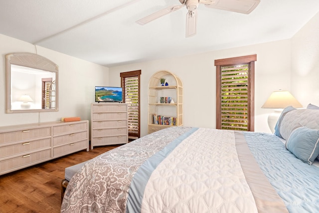 2721 Poipu Rd Unit 100, Koloa, HI 96756 - bedroom with dark wood-style floors and ceiling fan