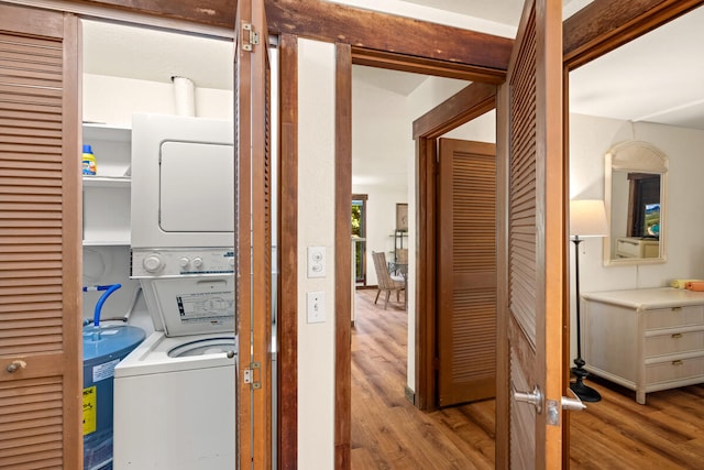 2721 Poipu Rd Unit 100, Koloa, HI 96756 - washroom with estacked washer and dryer and wood finished floors