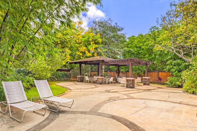2721 Poipu Rd Unit 100, Koloa, HI 96756 - fenced backyard featuring outdoor dining area, a pergola, and a patio area