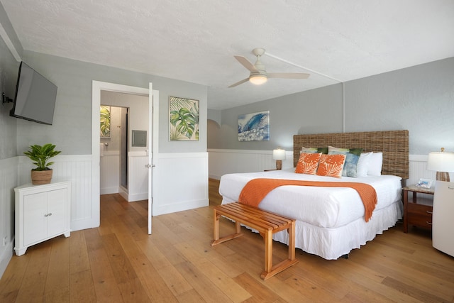 5061 Lawai Rd Unit 323, Koloa, HI 96756 - bedroom with light wood-style flooring, wainscoting, and a ceiling fan