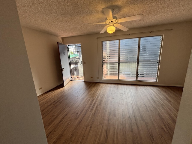 33 Hualalai St Unit 203, Hilo, HI 96720 - spare room with a textured ceiling, wood finished floors, baseboards, and a ceiling fan