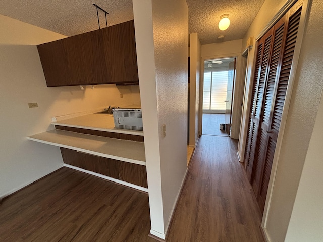 33 Hualalai St Unit 203, Hilo, HI 96720 - corridor with a textured ceiling, wood finished floors, baseboards, and a textured wall