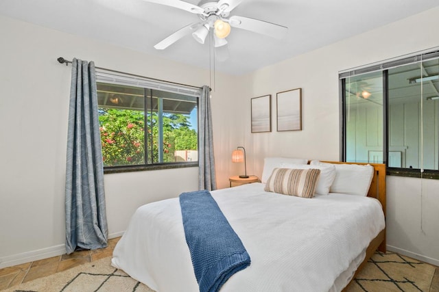 4465 Aku Rd, Hanalei, HI 96722 - bedroom with baseboards, a ceiling fan, and stone finish flooring