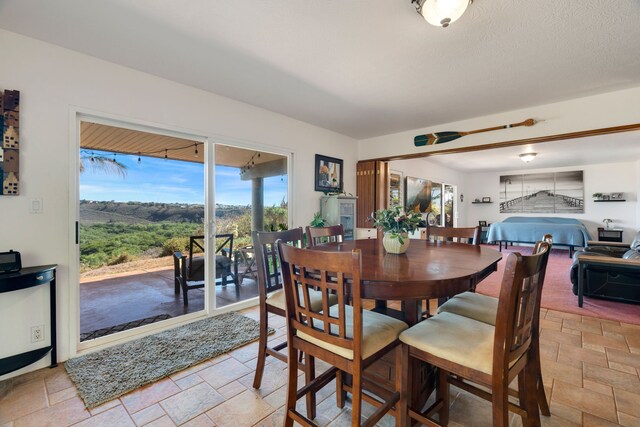 3719 Uwao St, Hanapepe, HI 96716 - dining space featuring stone tile flooring and healthy amount of natural light