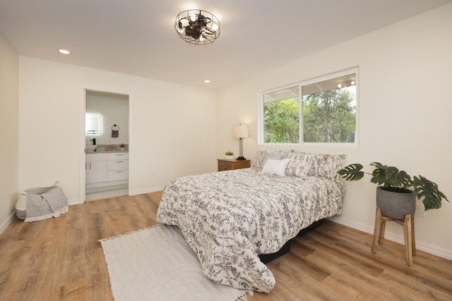 15-1042 Amau Rd, Keaau, HI 96749 - bedroom featuring light wood-style floors, baseboards, recessed lighting, and ensuite bath