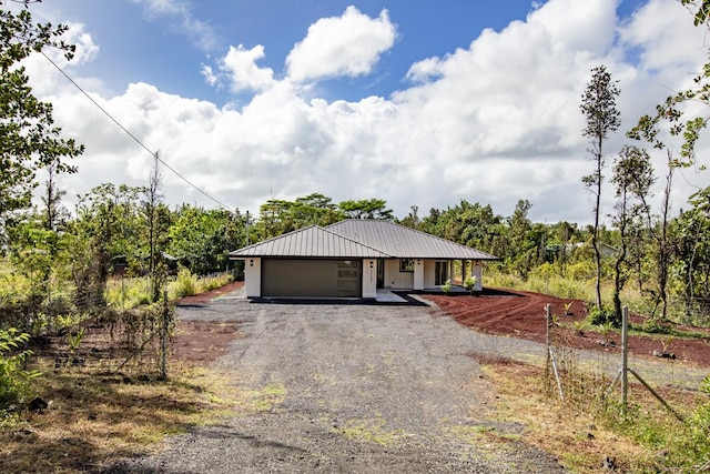15-1042 Amau Rd, Keaau, HI 96749 - view of front of house with a garage, driveway, and metal roof