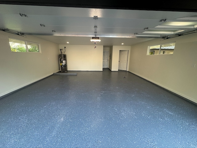 15-1042 Amau Rd, Keaau, HI 96749 - garage featuring baseboards, secured water heater, and a garage door opener
