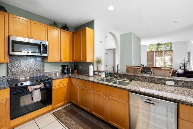 69-555 Waikoloa Beach Dr Unit 2605, Waikoloa, HI 96738 - kitchen with appliances with stainless steel finishes, a sink, dark stone counters, light tile patterned floors, and tasteful backsplash
