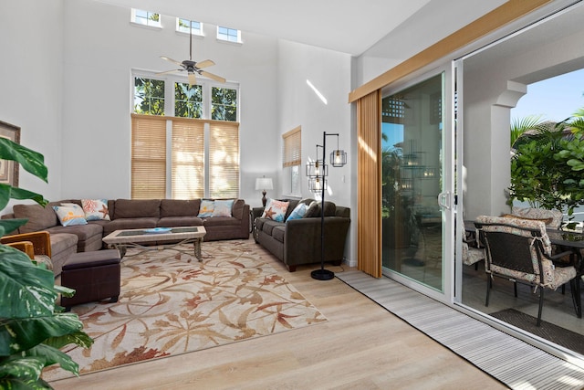 69-555 Waikoloa Beach Dr Unit 2605, Waikoloa, HI 96738 - living room featuring light wood-type flooring, healthy amount of natural light, a ceiling fan, and a high ceiling