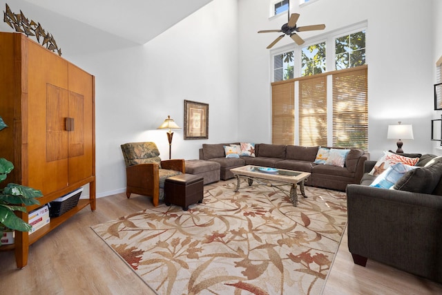 69-555 Waikoloa Beach Dr Unit 2605, Waikoloa, HI 96738 - living room with a towering ceiling, a ceiling fan, and light wood finished floors