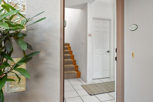 69-555 Waikoloa Beach Dr Unit 2605, Waikoloa, HI 96738 - hall featuring light tile patterned floors, stairway, and baseboards