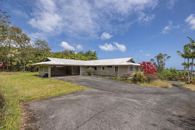 17-549 Ipuaiwaha St, Keaau, HI 96749 - ranch-style home featuring asphalt driveway, an attached carport, a front yard, and metal roof