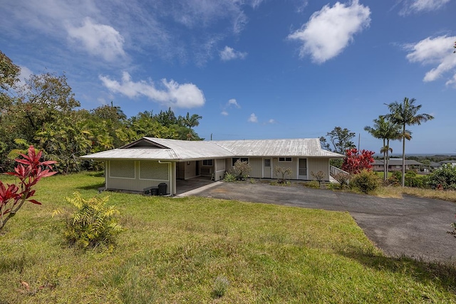 17-549 Ipuaiwaha St, Keaau, HI 96749 - rear view of house featuring asphalt driveway, metal roof, a yard, and a carport