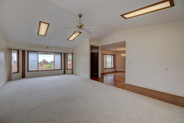 17-549 Ipuaiwaha St, Keaau, HI 96749 - spare room featuring carpet flooring, vaulted ceiling, a ceiling fan, a chandelier, and wood finished floors