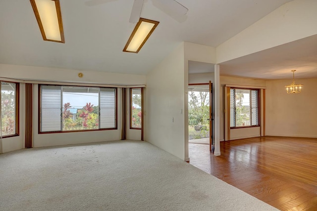 17-549 Ipuaiwaha St, Keaau, HI 96749 - empty room with lofted ceiling, ceiling fan, a chandelier, and wood finished floors