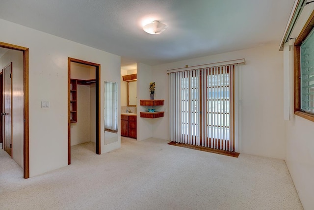 17-549 Ipuaiwaha St, Keaau, HI 96749 - unfurnished bedroom with light carpet, a closet, a spacious closet, and ensuite bathroom