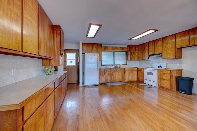 17-549 Ipuaiwaha St, Keaau, HI 96749 - kitchen featuring white appliances, brown cabinets, a sink, and decorative backsplash