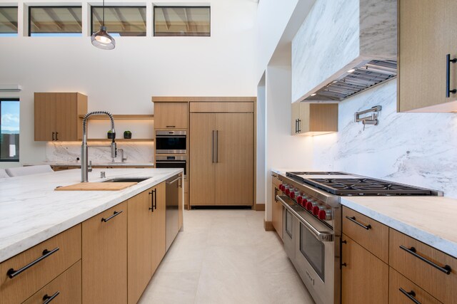 68-1051 Ke Kailani Dr, Kamuela, HI 96743 - kitchen featuring stainless steel appliances, premium range hood, a sink, tasteful backsplash, and light stone countertops