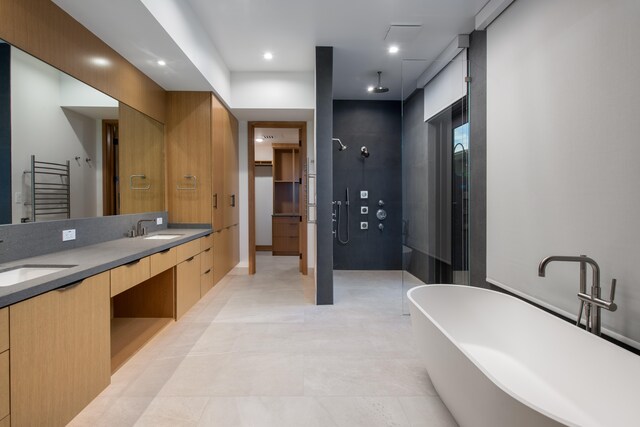 68-1051 Ke Kailani Dr, Kamuela, HI 96743 - bathroom featuring a stall shower, a freestanding tub, radiator heating unit, double vanity, and tile patterned flooring