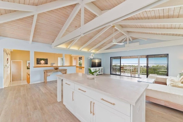 77-172 Kekai Pl, Kailua-Kona, HI 96740 - kitchen featuring open floor plan, wooden ceiling with exposed beams, white cabinets, light wood-type flooring, and light stone counters