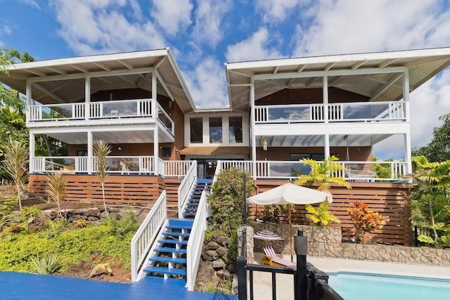 77-172 Kekai Pl, Kailua-Kona, HI 96740 - rear view of property featuring a balcony, stairs, and an outdoor pool