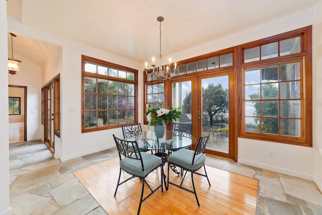 73-4310 Huehue St, Kailua-Kona, HI 96740 - dining space with french doors, a chandelier, stone tile flooring, and baseboards