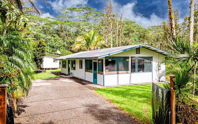 14-3377 Mauna Kea Rd, Pahoa, HI 96778 - view of front of property with a sunroom and driveway