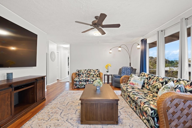 1646 Oneawa Pl, Hilo, HI 96720 - living area with wood finished floors, a textured ceiling, ceiling fan, and baseboards