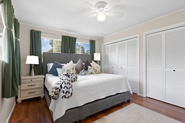 1646 Oneawa Pl, Hilo, HI 96720 - bedroom featuring two closets, dark wood-type flooring, baseboards, a ceiling fan, and ornamental molding