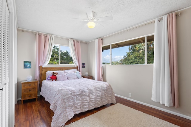 1646 Oneawa Pl, Hilo, HI 96720 - bedroom with wood finished floors, a textured ceiling, a ceiling fan, and baseboards