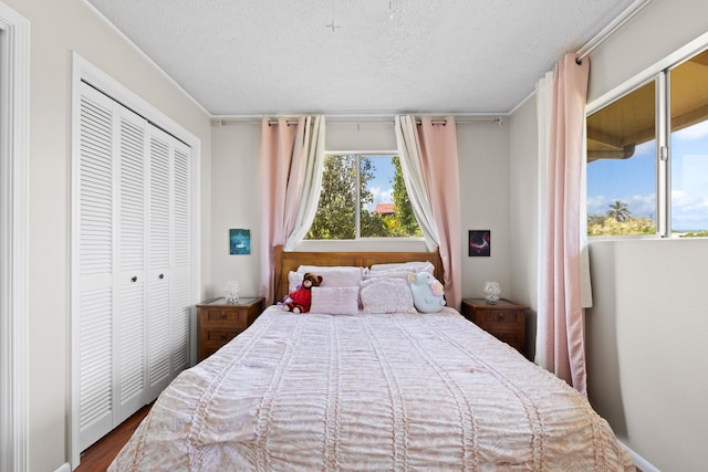 1646 Oneawa Pl, Hilo, HI 96720 - bedroom with multiple windows, a textured ceiling, a closet, and wood finished floors