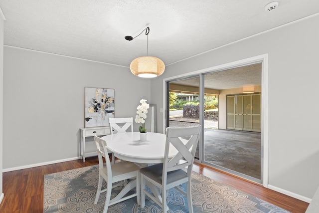 1646 Oneawa Pl, Hilo, HI 96720 - dining area with wood finished floors, baseboards, and a textured ceiling