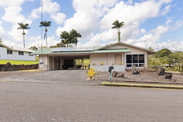 1646 Oneawa Pl, Hilo, HI 96720 - view of front facade with asphalt driveway, solar panels, and an attached carport
