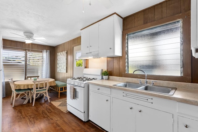 75-160 Lunapule Rd, Kailua-Kona, HI 96740 - kitchen featuring white gas range oven, ceiling fan, a sink, white cabinets, and wood walls