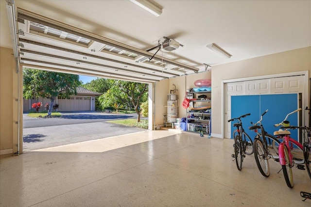 68-1122 Kaniku Dr Unit 111, Kamuela, HI 96743 - garage featuring a garage door opener and strapped water heater