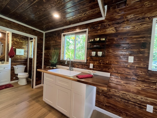 12-7010 Nahokulele St, Pahoa, HI 96778 - kitchen with a sink, wooden walls, wood ceiling, white cabinets, and healthy amount of natural light