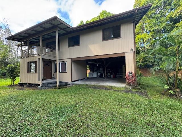 12-567 Aloha Rd, Pahoa, HI 96778 - back of house with a balcony, a yard, and an attached garage