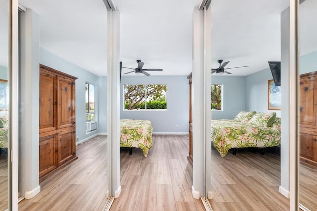 75-6081 Alii Dr Unit V101, Kailua-Kona, HI 96740 - bedroom with light wood-style flooring, baseboards, and a ceiling fan
