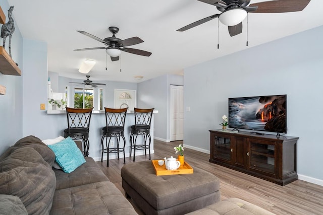 75-6081 Alii Dr Unit V101, Kailua-Kona, HI 96740 - living area with ceiling fan, wood finished floors, and baseboards